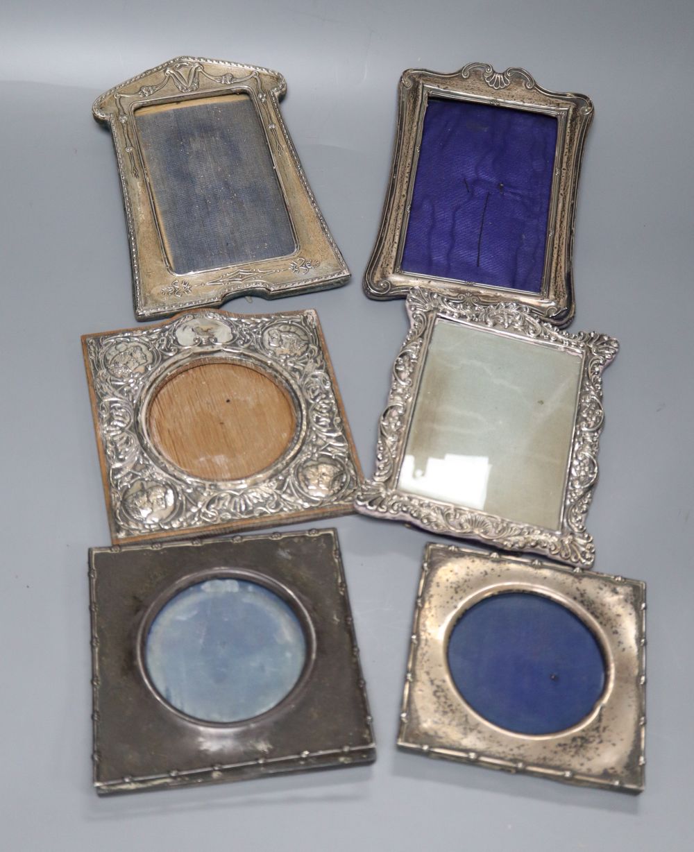 Six assorted early 20th century repousse silver mounted photograph frames, largest 19.3cm.